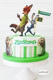 Zootopia themed birthday cake with Nick Wilde and Judy Hopps toppers and green striped fondant icing.