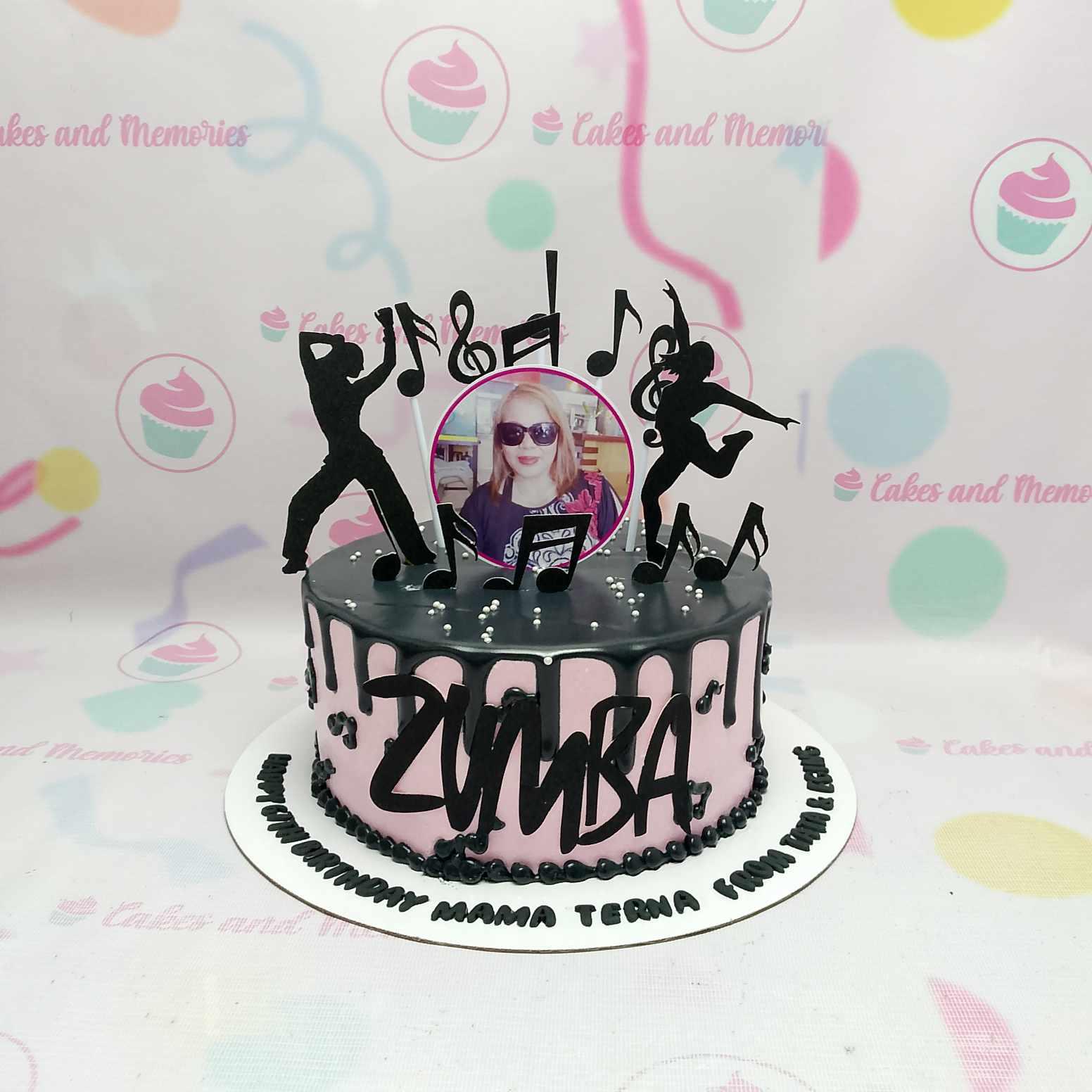 Pink Zumba themed birthday cake with black drip, music note toppers, and a photo of the celebrant.