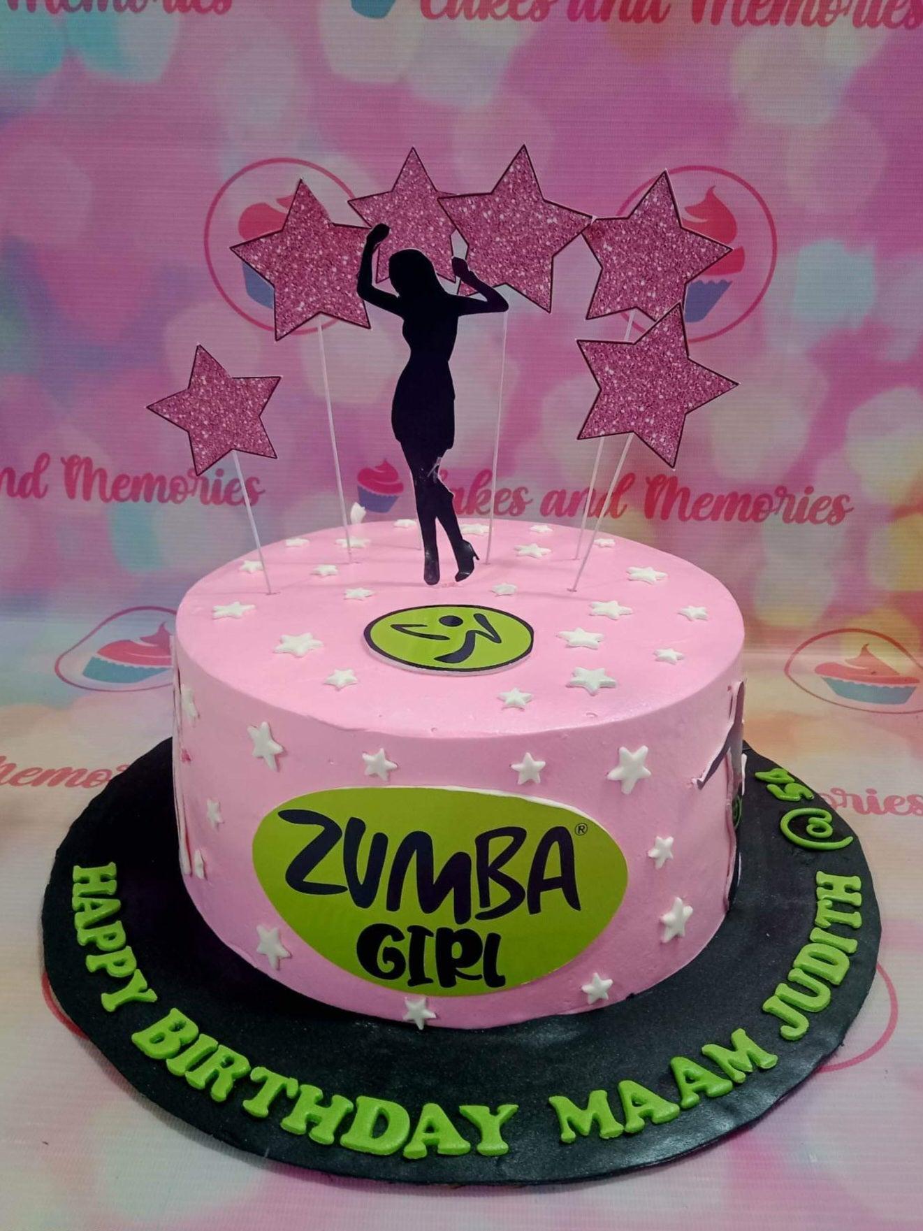 Pink Zumba themed birthday cake with a black silhouette dancer topper, glittery pink stars, and green Zumba Girl logos.