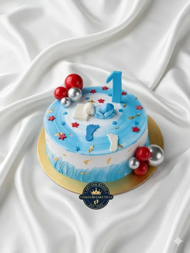 Blue and white baby boy first birthday cake with a sleeping baby fondant topper, blue number one, and red and silver decorative balls.