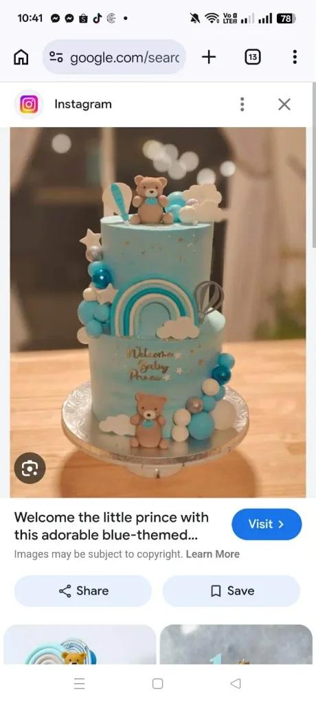 Two-tier light blue baby shower cake with fondant bears, rainbows, and hot air balloons.