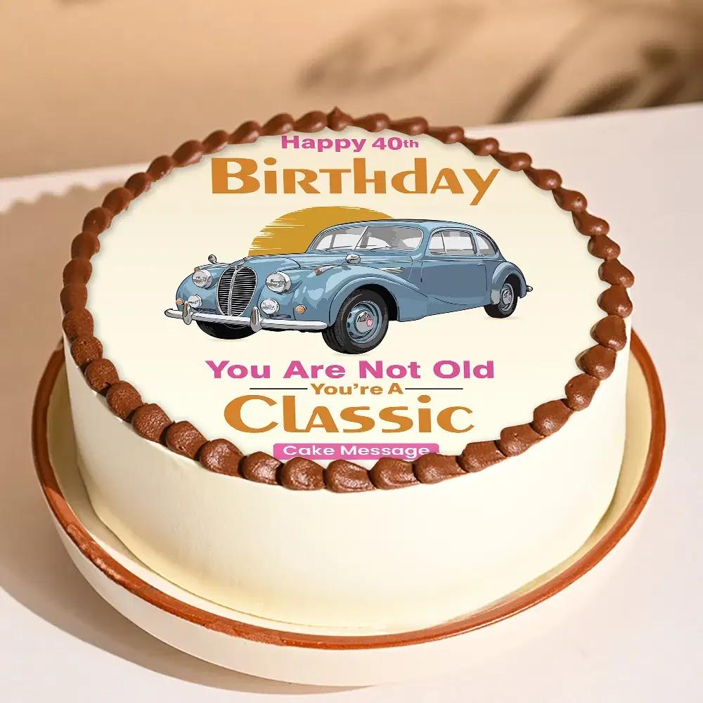 White round cake with a vintage blue car printout and chocolate icing border on top.