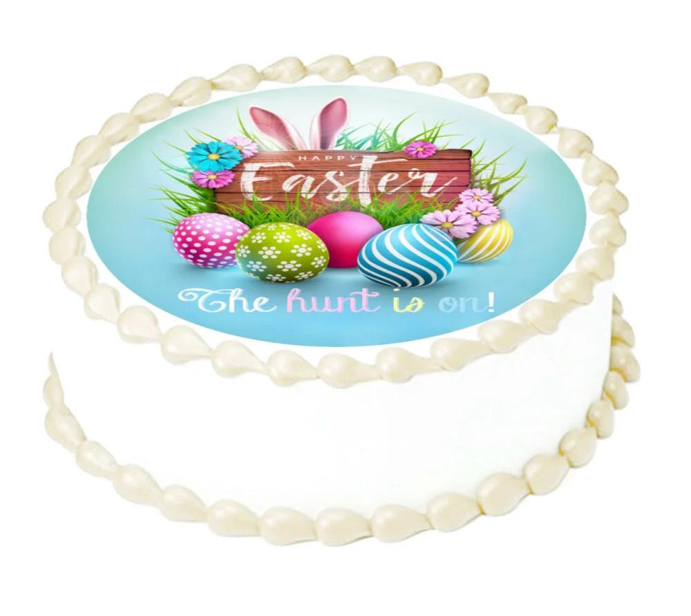 White round Easter cake with a large circular edible print featuring a bunny, colorful eggs, and 'Happy Easter' message.