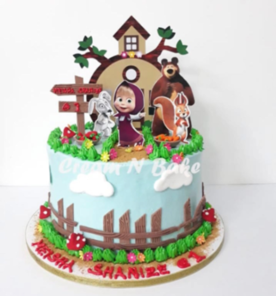 Masha and the Bear themed birthday cake with light blue icing, green grass borders, and character printouts.