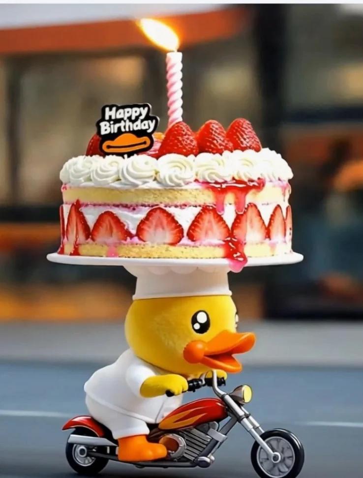 A strawberry shortcake with fresh strawberry slices on the side and top, featuring a Happy Birthday duck printout and a pink spiral candle.